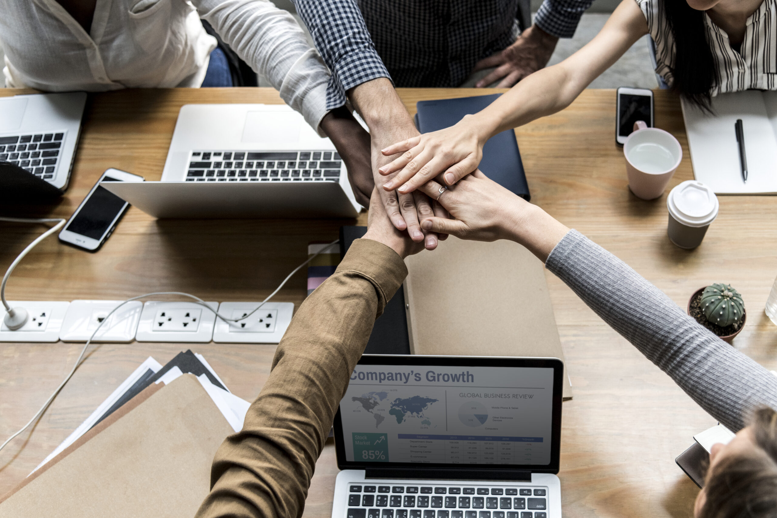 team-business-people-stacking-hands-scaled.jpg